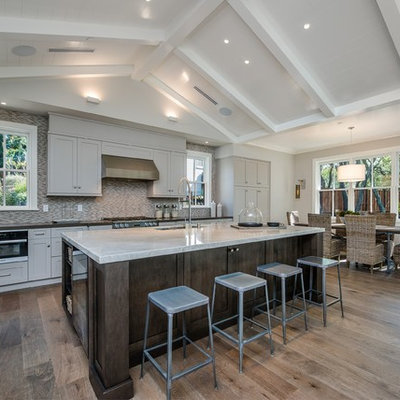 Eat-in kitchen - large cottage l-shaped light wood floor and beige floor eat-in kitchen idea in San Francisco with an undermount sink, shaker cabinets, gray cabinets, multicolored backsplash, stainless steel appliances, an island, quartzite countertops and matchstick tile backsplash