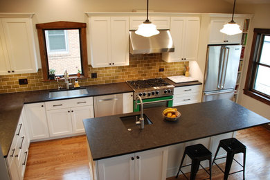 Large l-shaped light wood floor kitchen photo in Chicago with a single-bowl sink, flat-panel cabinets, white cabinets, granite countertops, brown backsplash, stainless steel appliances and an island