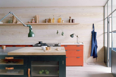Inspiration for a scandinavian kitchen in London with orange cabinets.