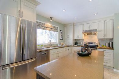 Inspiration for a transitional l-shaped eat-in kitchen remodel in Toronto with an island
