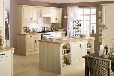 Design ideas for a large contemporary kitchen/diner in Other with raised-panel cabinets, yellow cabinets, wood worktops, white splashback, metro tiled splashback, stainless steel appliances, light hardwood flooring and an island.