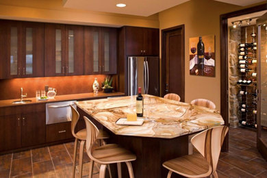 Example of a large u-shaped porcelain tile and brown floor eat-in kitchen design in Minneapolis with an undermount sink, flat-panel cabinets, dark wood cabinets, onyx countertops, red backsplash, mosaic tile backsplash, stainless steel appliances, an island and orange countertops