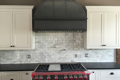 Example of a transitional kitchen design in Dallas with shaker cabinets, white cabinets, white backsplash, subway tile backsplash and stainless steel appliances