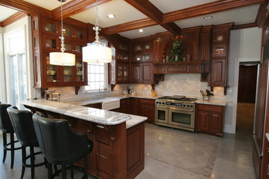 Large elegant u-shaped porcelain tile and beige floor eat-in kitchen photo in Other with an undermount sink, raised-panel cabinets, dark wood cabinets, marble countertops, white backsplash, marble backsplash, stainless steel appliances and a peninsula