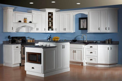 Example of a large minimalist l-shaped light wood floor kitchen pantry design in Other with raised-panel cabinets, white cabinets, blue backsplash and an island