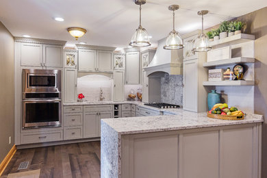 Large transitional u-shaped dark wood floor and brown floor kitchen photo in Other with an undermount sink, raised-panel cabinets, white cabinets, quartzite countertops, white backsplash, subway tile backsplash, stainless steel appliances and a peninsula