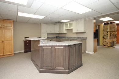 Example of a mid-sized transitional u-shaped open concept kitchen design in Chicago with an undermount sink, raised-panel cabinets, white cabinets, granite countertops and a peninsula