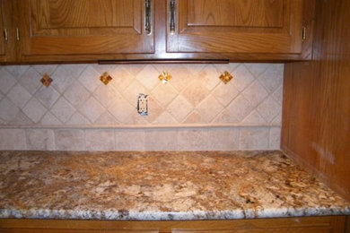 Kitchen - kitchen idea in Kansas City with raised-panel cabinets, medium tone wood cabinets, granite countertops, beige backsplash and ceramic backsplash