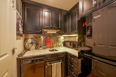 Example of a small transitional l-shaped light wood floor and beige floor enclosed kitchen design in Boston with an undermount sink, recessed-panel cabinets, black cabinets, granite countertops, metallic backsplash, metal backsplash, stainless steel appliances and no island