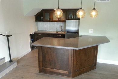 Example of a small minimalist u-shaped light wood floor open concept kitchen design in San Diego with a single-bowl sink, shaker cabinets, laminate countertops, beige backsplash, stainless steel appliances and a peninsula