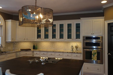 Example of a large trendy l-shaped enclosed kitchen design in Charlotte with an island