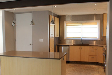 Photo of a medium sized classic u-shaped kitchen/diner in Edmonton with a double-bowl sink, raised-panel cabinets, light wood cabinets, composite countertops, metallic splashback, matchstick tiled splashback, stainless steel appliances, ceramic flooring and an island.