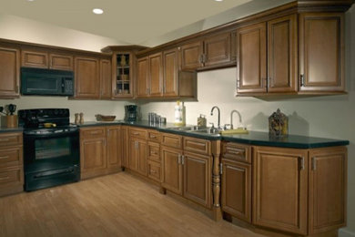 Large l-shaped medium tone wood floor eat-in kitchen photo in Milwaukee with a double-bowl sink, dark wood cabinets, black appliances and no island