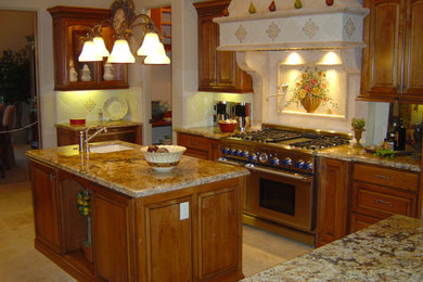 Example of a large classic u-shaped ceramic tile eat-in kitchen design in Sacramento with a double-bowl sink, recessed-panel cabinets, medium tone wood cabinets, granite countertops, multicolored backsplash, stone slab backsplash, stainless steel appliances and an island