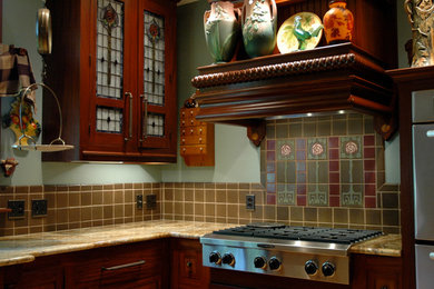 Example of a kitchen design in Columbus with quartz countertops, green backsplash and paneled appliances