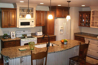 Example of a mid-sized l-shaped ceramic tile open concept kitchen design in Other with an undermount sink, medium tone wood cabinets, granite countertops, stainless steel appliances and an island