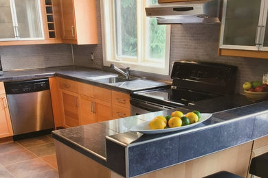 Inspiration for a mid-sized contemporary u-shaped ceramic tile and multicolored floor eat-in kitchen remodel in Nashville with an undermount sink, shaker cabinets, light wood cabinets, tile countertops, gray backsplash, ceramic backsplash, stainless steel appliances and a peninsula