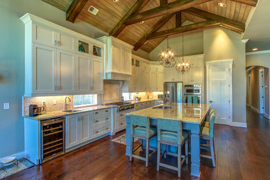 Inspiration for a mid-sized farmhouse l-shaped dark wood floor open concept kitchen remodel in Orange County with a double-bowl sink, shaker cabinets, white cabinets, marble countertops, beige backsplash, mosaic tile backsplash, stainless steel appliances and an island