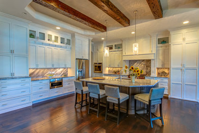 Inspiration for a mid-sized country l-shaped dark wood floor open concept kitchen remodel in Orange County with a double-bowl sink, shaker cabinets, white cabinets, marble countertops, stainless steel appliances, an island, gray backsplash and stone slab backsplash