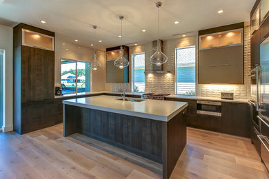 Inspiration for a mid-sized contemporary u-shaped medium tone wood floor open concept kitchen remodel in Orange County with an undermount sink, flat-panel cabinets, dark wood cabinets, concrete countertops, gray backsplash, porcelain backsplash, stainless steel appliances and an island