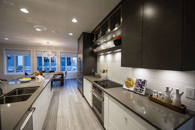 Example of a mid-sized trendy l-shaped medium tone wood floor and gray floor open concept kitchen design in Other with a double-bowl sink, flat-panel cabinets, dark wood cabinets, quartzite countertops, white backsplash, porcelain backsplash, stainless steel appliances and an island