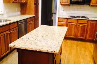 Photo of a medium sized l-shaped enclosed kitchen in Cincinnati with an island.