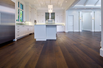 Inspiration for a large contemporary l-shaped dark wood floor eat-in kitchen remodel in New York with a double-bowl sink, recessed-panel cabinets, white cabinets, marble countertops, green backsplash, glass tile backsplash, stainless steel appliances and an island