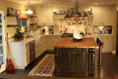 Mid-sized cottage u-shaped dark wood floor eat-in kitchen photo in Los Angeles with a farmhouse sink, raised-panel cabinets, white cabinets, marble countertops, multicolored backsplash, stone tile backsplash, stainless steel appliances and an island