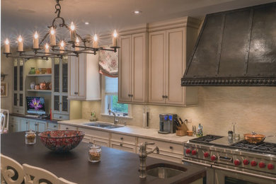 Example of a mid-sized classic single-wall dark wood floor and brown floor enclosed kitchen design in Chicago with a double-bowl sink, recessed-panel cabinets, white cabinets, quartz countertops, beige backsplash, matchstick tile backsplash, stainless steel appliances and an island