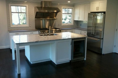 Mid-sized minimalist u-shaped slate floor eat-in kitchen photo in New York with an undermount sink, raised-panel cabinets, white cabinets, granite countertops, mosaic tile backsplash, stainless steel appliances and a peninsula