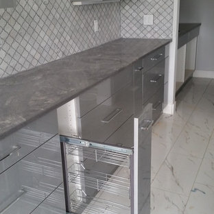 Inspiration for a mid-sized contemporary kitchen in Edmonton with flat-panel cabinets, grey cabinets, concrete benchtops, grey splashback, mosaic tile splashback and marble floors.