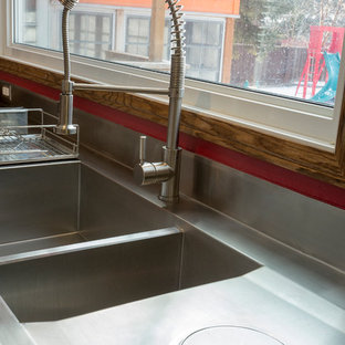 Industrial kitchen in Other with a double-bowl sink and stainless steel benchtops.