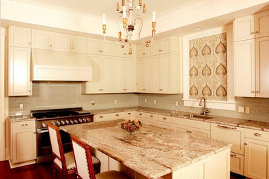 Eat-in kitchen - l-shaped dark wood floor eat-in kitchen idea in New Orleans with a single-bowl sink, shaker cabinets, white cabinets, granite countertops, gray backsplash, ceramic backsplash, stainless steel appliances and an island