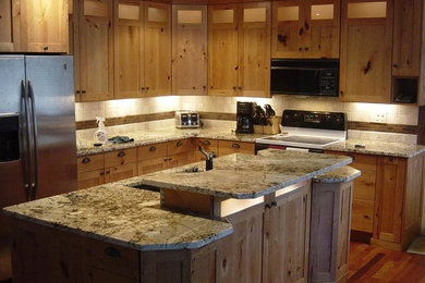 Medium tone wood floor kitchen photo in Denver with recessed-panel cabinets, granite countertops, white backsplash, ceramic backsplash and an island