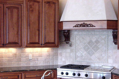 Inspiration for a kitchen remodel in New Orleans with raised-panel cabinets, medium tone wood cabinets, granite countertops and beige backsplash