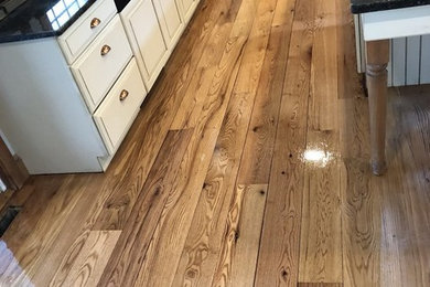 Mid-sized elegant medium tone wood floor and brown floor kitchen photo in Philadelphia