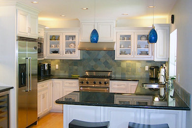 Inspiration for a mid-sized transitional l-shaped light wood floor eat-in kitchen remodel in San Francisco with an undermount sink, recessed-panel cabinets, white cabinets, granite countertops, green backsplash, ceramic backsplash, stainless steel appliances and an island