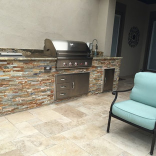 Mid-sized minimalist single-wall travertine floor eat-in kitchen photo in Austin with a single-bowl sink, flat-panel cabinets, stainless steel cabinets, granite countertops, multicolored backsplash, stone slab backsplash, stainless steel appliances and no island