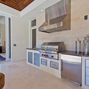 Tropical kitchen ideas - Island style kitchen photo in Miami