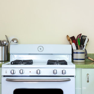 Photo of a mid-sized contemporary l-shaped separate kitchen in Boston with a drop-in sink, flat-panel cabinets, green cabinets, quartz benchtops, white appliances, no island and green benchtop.