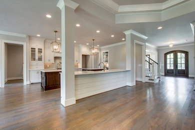 Example of a large arts and crafts open concept kitchen design in Nashville with beaded inset cabinets, white cabinets and two islands