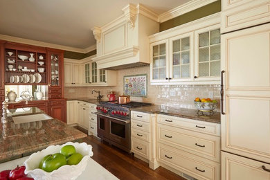 Photo of a large traditional l-shaped kitchen/diner in Baltimore with a submerged sink, raised-panel cabinets, white cabinets, granite worktops, white splashback, ceramic splashback, stainless steel appliances, medium hardwood flooring and an island.