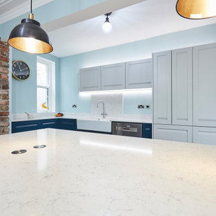 This is an example of a mid-sized l-shaped eat-in kitchen in Other with a farmhouse sink, shaker cabinets, blue cabinets, marble benchtops, white splashback, marble splashback, stainless steel appliances, porcelain floors, multiple islands, blue floor, white benchtop and coffered.