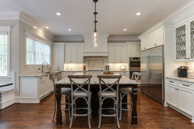 Idéer för ett stort klassiskt vit kök, med en rustik diskho, luckor med infälld panel, vita skåp, granitbänkskiva, vitt stänkskydd, rostfria vitvaror, mellanmörkt trägolv, en köksö och brunt golv