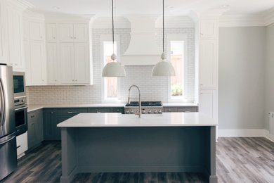 Eat-in kitchen - country single-wall light wood floor and gray floor eat-in kitchen idea in Other with a farmhouse sink, beaded inset cabinets, gray cabinets, quartz countertops, white backsplash, subway tile backsplash, stainless steel appliances, an island and white countertops