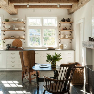 Country single-wall eat-in kitchen in Boston with shaker cabinets, white cabinets, white splashback, subway tile splashback, cement tiles, grey floor and grey benchtop.