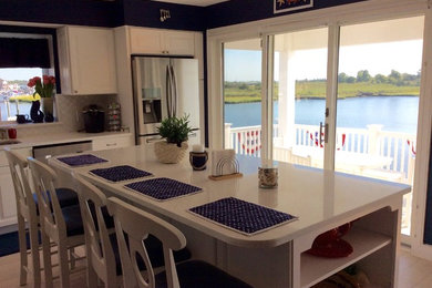 Eat-in kitchen - large coastal l-shaped ceramic tile and beige floor eat-in kitchen idea in Philadelphia with an undermount sink, raised-panel cabinets, white cabinets, quartz countertops, white backsplash, ceramic backsplash, stainless steel appliances and an island