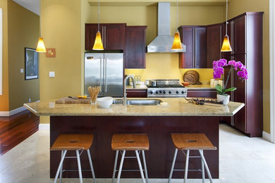 Mid-sized trendy l-shaped eat-in kitchen photo in San Francisco with a double-bowl sink, shaker cabinets, medium tone wood cabinets, granite countertops, stainless steel appliances and an island