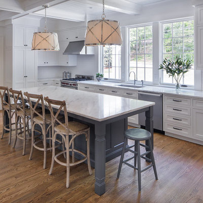 Inspiration for a mid-sized transitional l-shaped medium tone wood floor and brown floor kitchen remodel in Atlanta with an undermount sink, shaker cabinets, white cabinets, white backsplash, stainless steel appliances, marble countertops, ceramic backsplash and an island