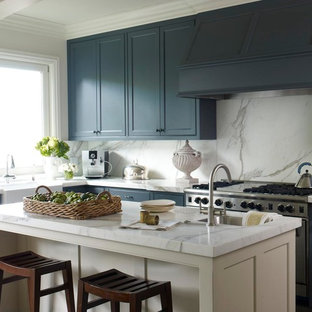 Elegant kitchen photo in San Francisco with a farmhouse sink, blue cabinets, marble countertops, white backsplash, stainless steel appliances and marble backsplash